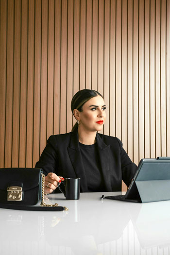 Woman setas behind the table